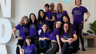 Participants posing on stairs after Wish Workout
