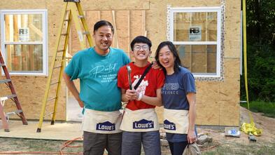 Manny pictured center with his parents on the construction site