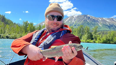 Teigan shows the fish he caught.