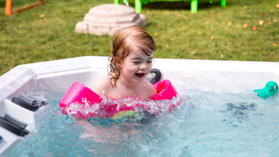 Spencer with floaties in her hot tub