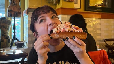 Roux eating a sandwich in New York