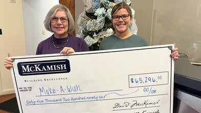Naley McKamish, director of marketing presenting a $65,296 donation to Stephanie Pugliese, Make-A-Wish Director of Development.
