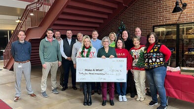 Employees from Pitt Ohio present Make-A-Wish Director of Development, Stephanie Pugliese with a donation to local wishes.