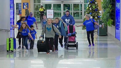 Two wish kid girls running to their airplane in the terminal