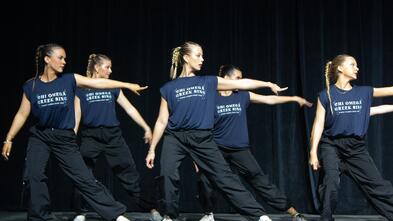 A group of Chi Omega's perform onstage.
