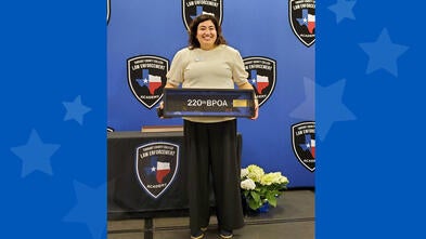 woman smiling behind a podium