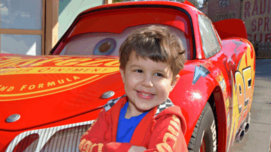 Louis standing in front of Lightning McQueen