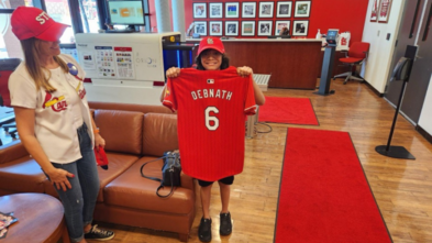 Sid holding Cardinal's jersey