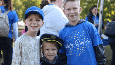 Three children standing together at Walk For Wishes