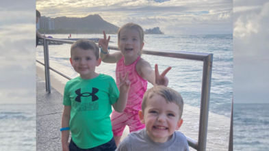 Wish kid Aileen with her brothers, posing at sunset in Hawaii