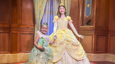 Cassandra takes a picture with Princess Belle