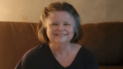 Debi sitting on a couch