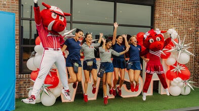 Waiters for Wishes event photo with mascots and staff jumping 