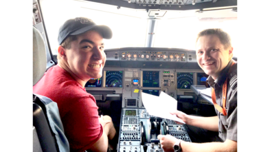 Max sitting in the cockpit of the plane on his way to Los Angeles in 2017.