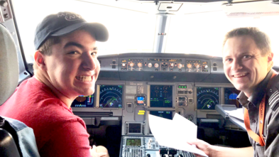 Max sitting in the cockpit of the plane on his way to Los Angeles in 2017.