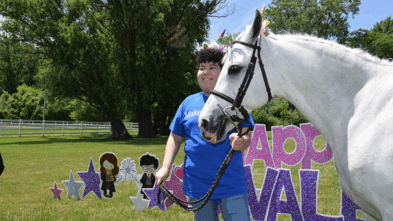 Valentina smiling with a unicorn