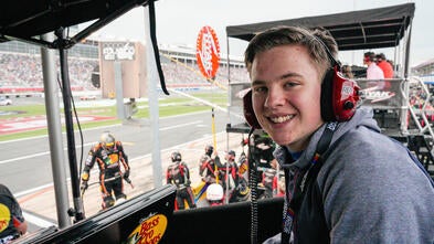 Caleb smiling at the racetrack