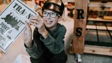 Honour holding Train sign