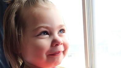Hailey smiling looking out a window