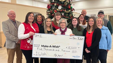 CEO Ray Yeager, (far left) presenting Stephanie Pugliese, director of development with a $5,000 donation