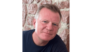 Peter smiling in a photo