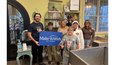 wish kid holding bird with family