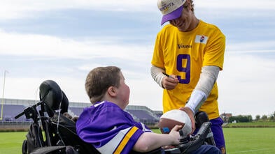 Nash on the practice field with former vikings quarterback JJ McCarthy