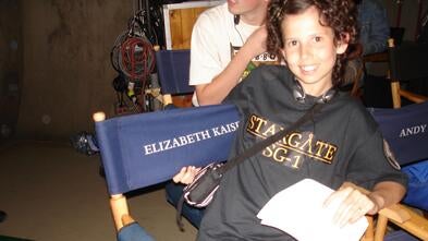Hannah on a director's chair on the set of Stargate