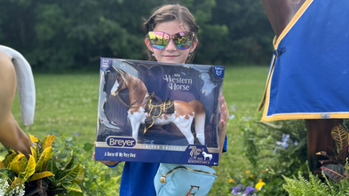 Ella holding a Breyer horse