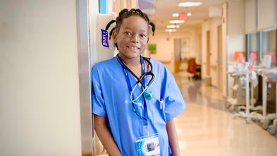 Wish kid Sophyii standing in a hospital for her wish to be a nurse