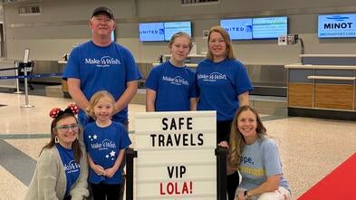 Tara with wish kid Lola and her family at the Minot Airport