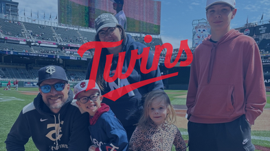 MN Twins logo on top of an image of people at the game