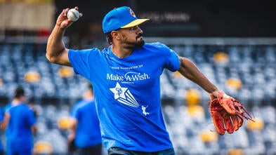 Saints player warming up in a Make-A-Wish t-shirt