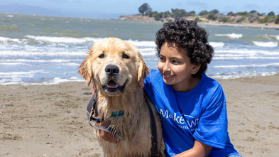 Anika poses joyfully with her new dog, Rudder. 