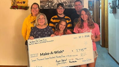 The Kreutzer family presenting their donation from this year's softball tournament