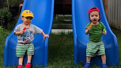 Luciano and Neil in front of their playset.