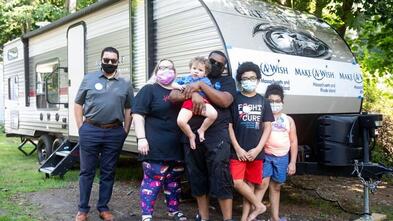 Wish child Treyvon receiving his camper wish