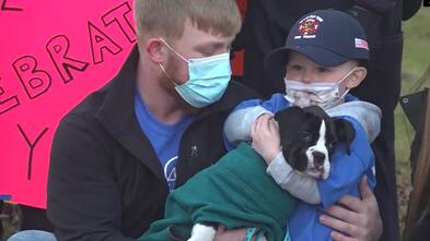 Killian and his father pose with his new puppy, Chase.