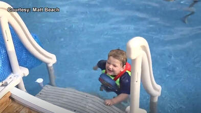 Anthony prepares to climb up the latter in his pool