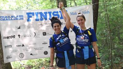 Hikers holding hands at the finish line