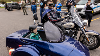 Wish kid Cyrus as Superhero MindsEye rides in the sidecar.