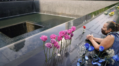 Woman takes a moment at 9/11 memorial