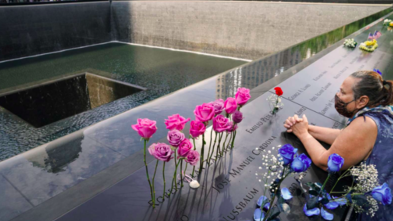 Woman takes a moment at 9/11 memorial
