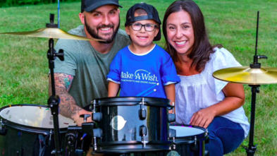 Cam receives a drum set with his parents