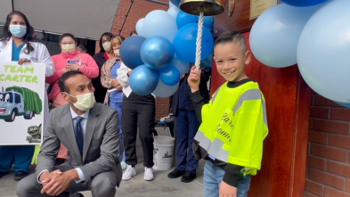 Carter rings the Chemo Bell at Turlock Emanuel Medical Center