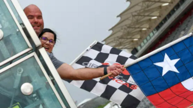 Knox's parents waving the racing flag