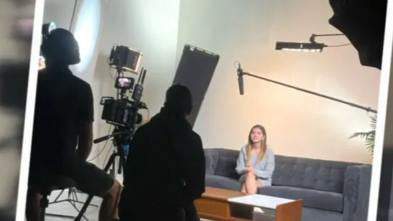 Daysia sitting on the couch being filmed for her documentary.