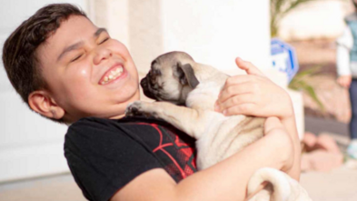 Jean's smile cannot be contained meeting his pug