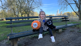 Wish kid Joanna sitting on a bench in a park in New York City with stuffed animals designed to look like her imaginary friends