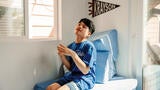 Wish kid Krayson sitting in his new therapy clubhouse